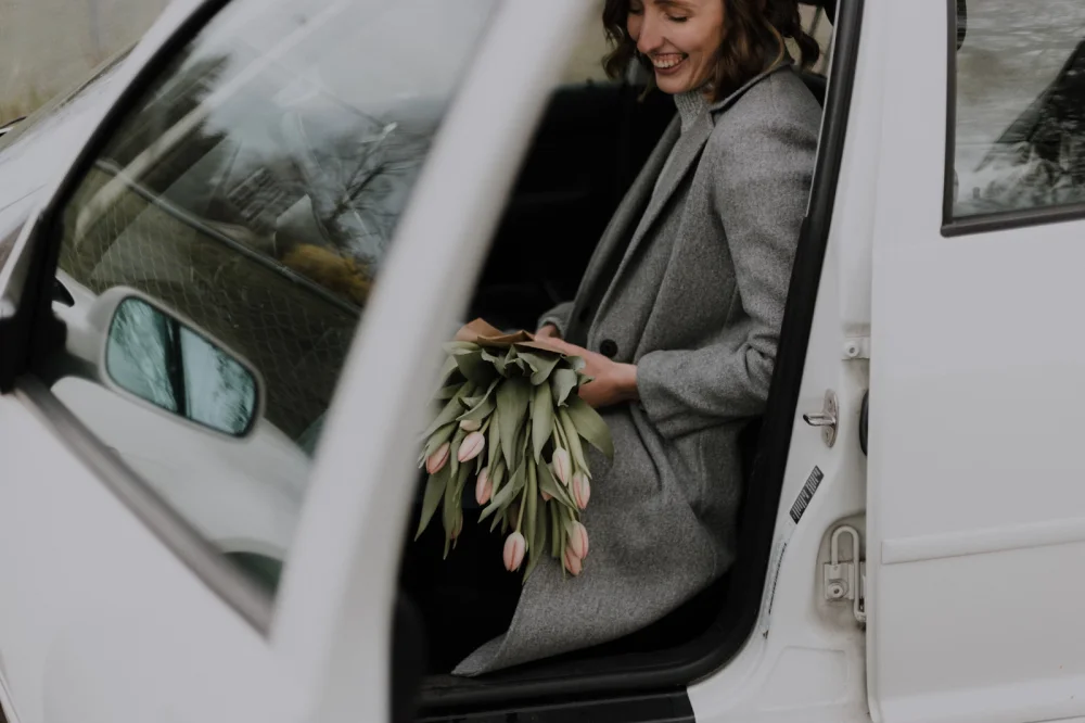 women getting out of car with flowers