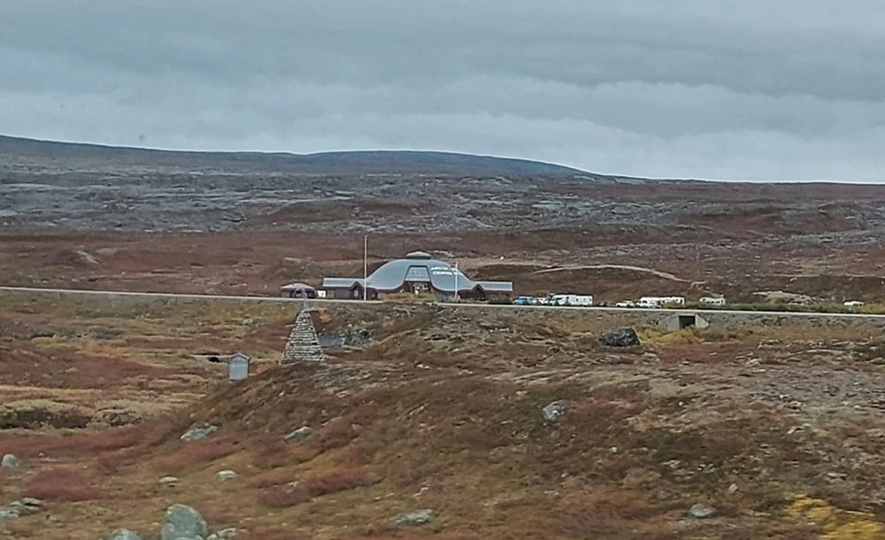 The marker denoting crossing into the Arctic Circle, well into the tundra zone.