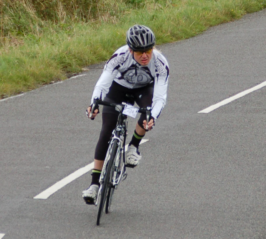 Stu Thomas cycling on a road