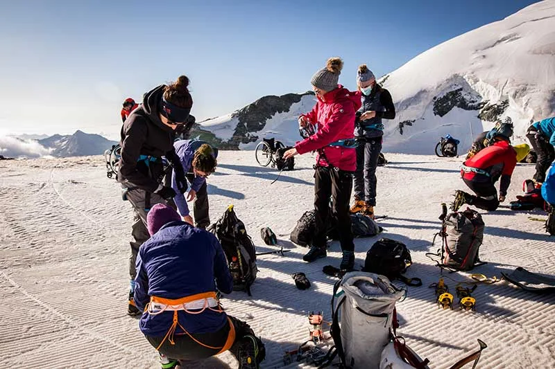 Participants fastening the harnesses and crampons ahead of the My first 4000er peak Allalinhornjpg